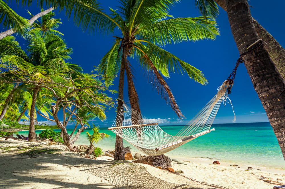 Coconut palm fringed beach with hammock, fiji