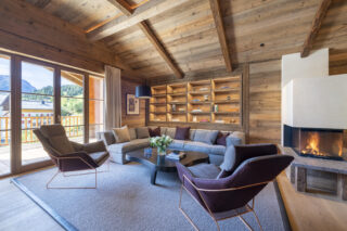 Lounge and open fire with balcony views at Chalech L in Lech