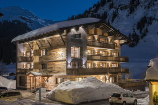 Exterior of the Nidus apartment building in Lech at night