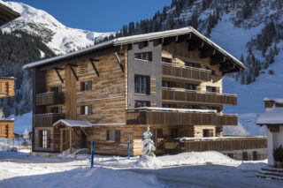Exterior view of the Nidus apartment building in Loch on a sunny winter day