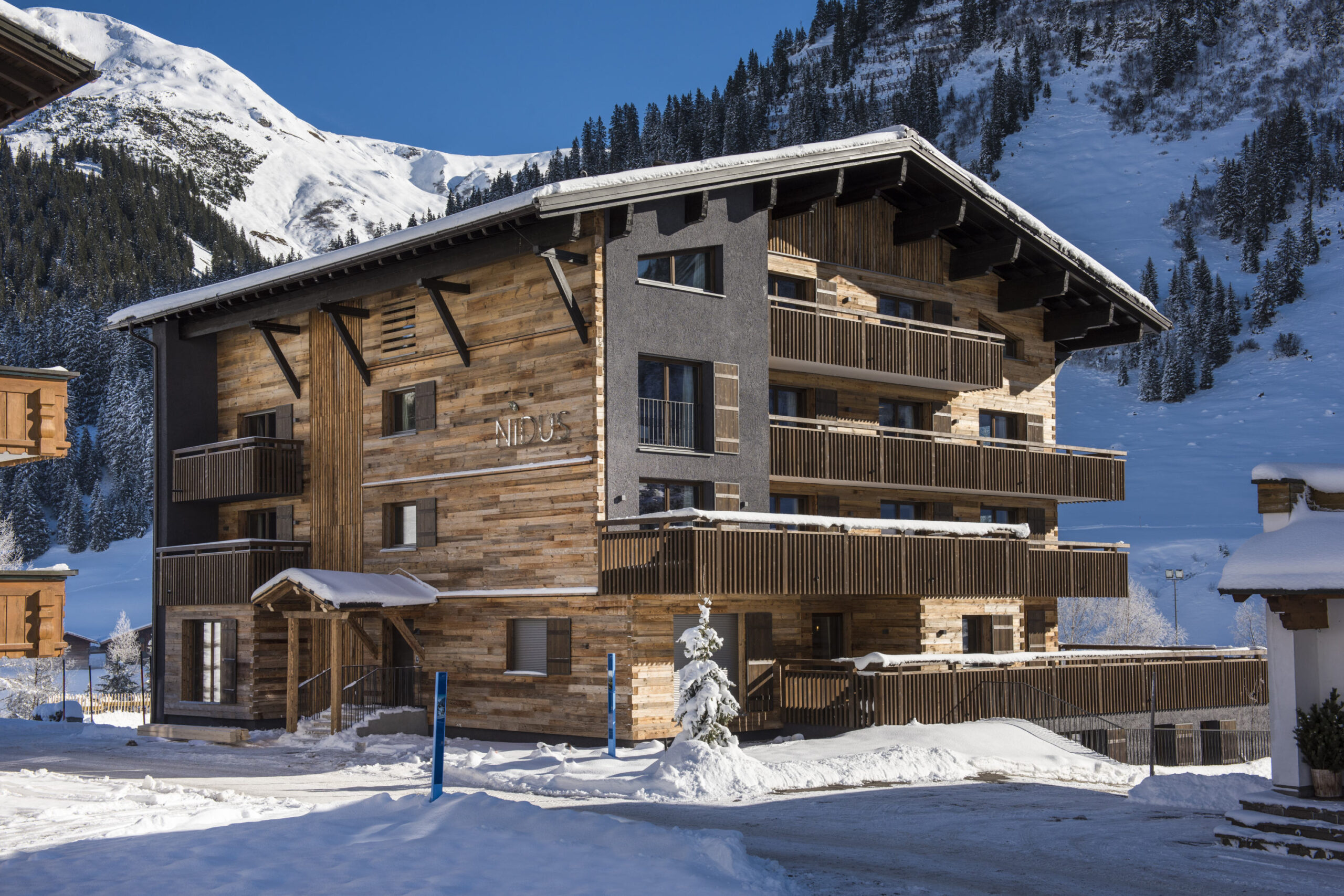 Exterior view of the Nidus apartment building in Loch on a sunny winter day