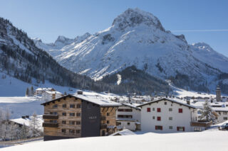 View over Lech on a sunny winter day with the Nidus apartment building in the foreground