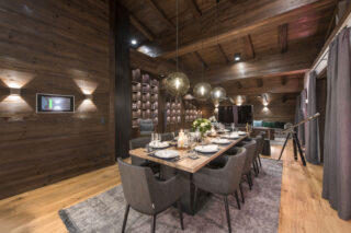 Dining table set for dinner and telescope for stargazing at Nidus Penthouse in LEch