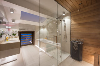 Master bedroom en suite bath and shower room with twin sinks and private sauna at Nidus Penthouse in Lech