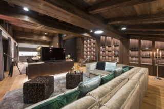 Luxurious sofas and cushions facing flat-screen TV at Nidus Penthouse in Lech