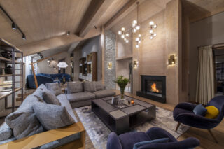 Living space with open fire at Chalet Altius in Meribel