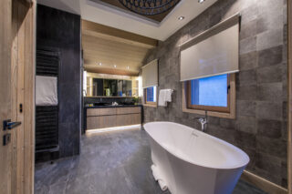 Master ensuite bathroom with freestanding bath and shower at Chalet Altius in Meribel