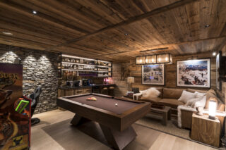 Games room with billiards table, arcade games and bar at Chalet la Loze in Méribel