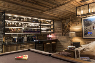 Billiard table and bar in games room at Chalet la Loze in Méribel