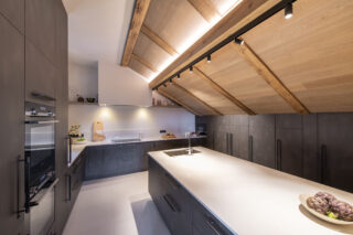Kitchen with built-in appliances and island worktop at Chalet la Loze in Méribel