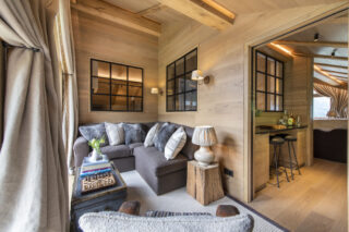 Corner sofa and armchair in TV snug at Chalet la Loze in Méribel