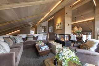 Living space with open fireplace at Chalet la Loze in Méribel