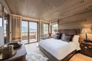 Double bedroom two with balcony and ensuite bathroom at Chalet la Loze in Méribel