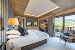 Bedroom five with balcony and mountain views at Chalet la Loze in Méribel
