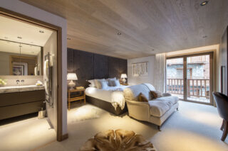 Double bedroom four with balcony and en suite shower room at Chalet la Loze in Méribel