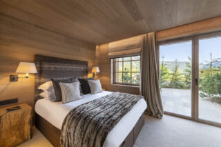 Double bedrom six with ground level terrace at Chalet la Loze in Méribel