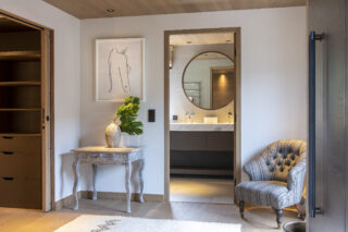 Dressing room and en suite bathroom in master bedroom at Chalet la Loze in Méribel