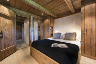 Double bedroom three with open door at Chalet Bibi in Verbier