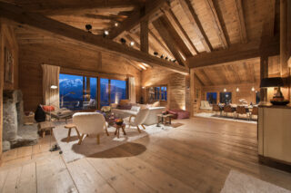 Open plan living and dining space in the evening at Chalet Bibi in Verbier