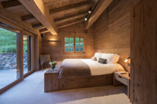 Master double bedroom with French doors opening to terrace at Chalet Bibi in Verbier