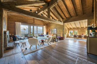 High-ceilinged open plan living and dining space at Chalet Bibi in Verbier