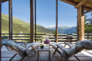 View over Verbier toward the Combins massif from the top floor balcony at Chalet Bibi in Verbier