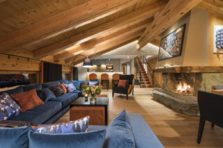 Lounge to breakfast bar with open fire at Entre Ciel et Terre in Verbier