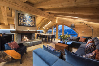 Living space with open fire and mountain views at Entre Ciel et Terre in Verbier