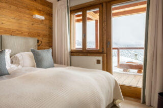 View through door opening to balcony in bedroom two at Chalet les Étrennes in Verbier