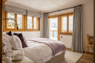 Bedroom three with balcony access at Chalet les Étrennes in Verbier