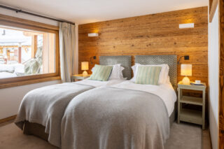 Twin single beds in bedroom five at Chalet les Étrennes in Verbier