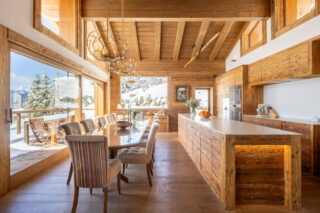 Dining room and open plan kitchen at Chalet les Étrennes in Verbier