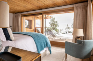 View from sliding windows opening to balcony in master bedroom suite at Chalet les Étrennes in Verbier