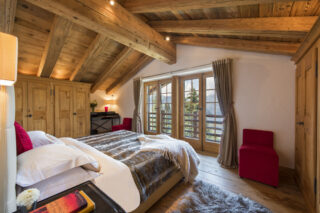 Master bedroom with balcony views at Chalet Milou in Verbier