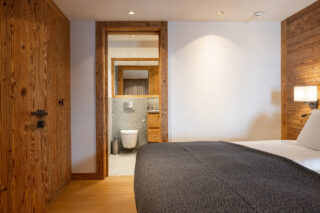Bedroom four with door to en suite bathroom at Chalet Pierrier in Verbier