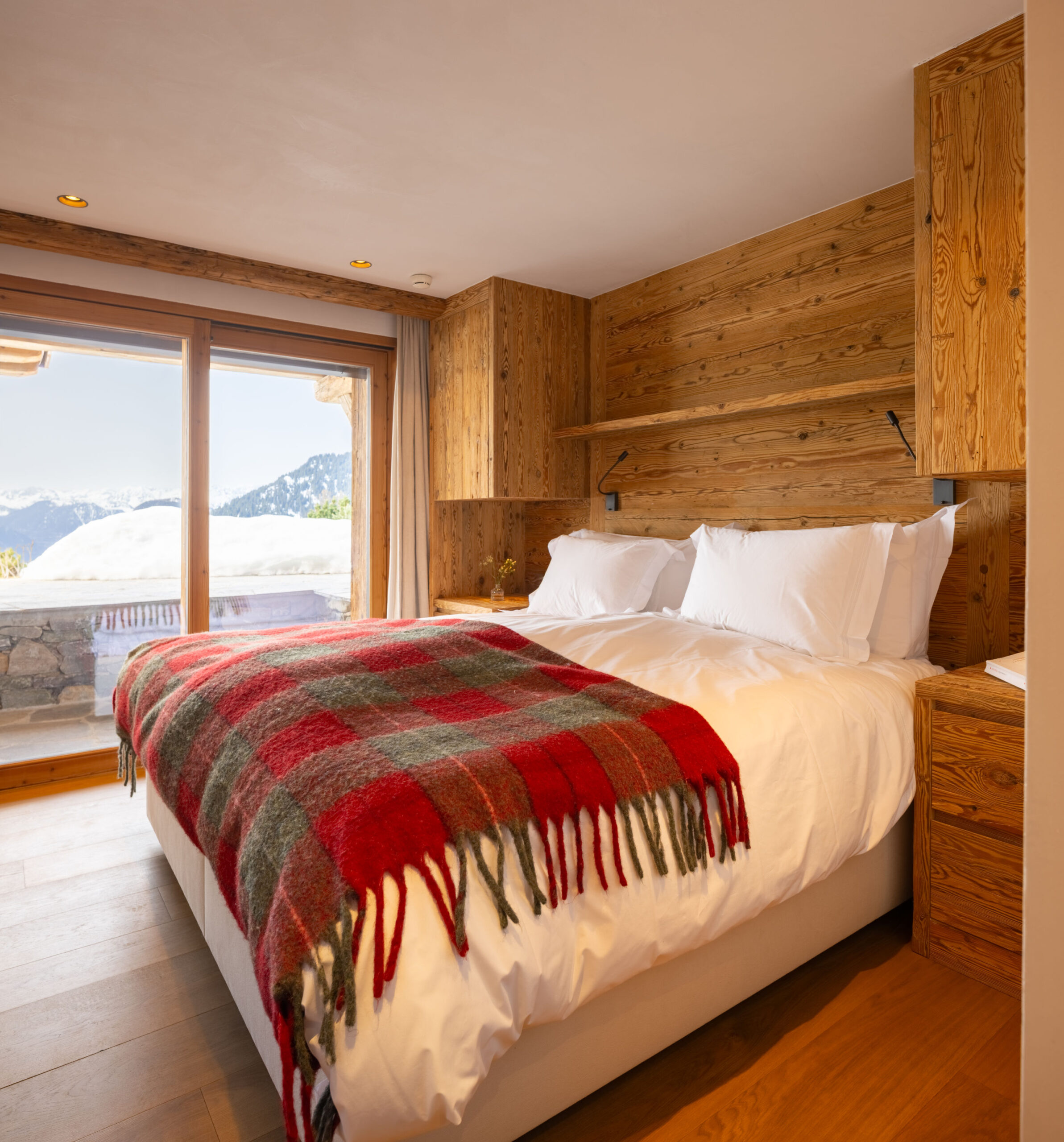 Bedroom two with terrace access at Chalet Pierrier in Verbier