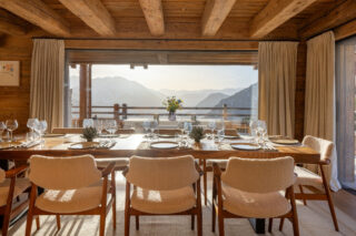 View of the sunlit mountains from the dining table at Chalet Pierrier in Verbier
