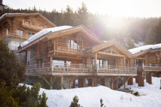 Exterior view of Chalet Pierrier in Verbier in low winter sunlight