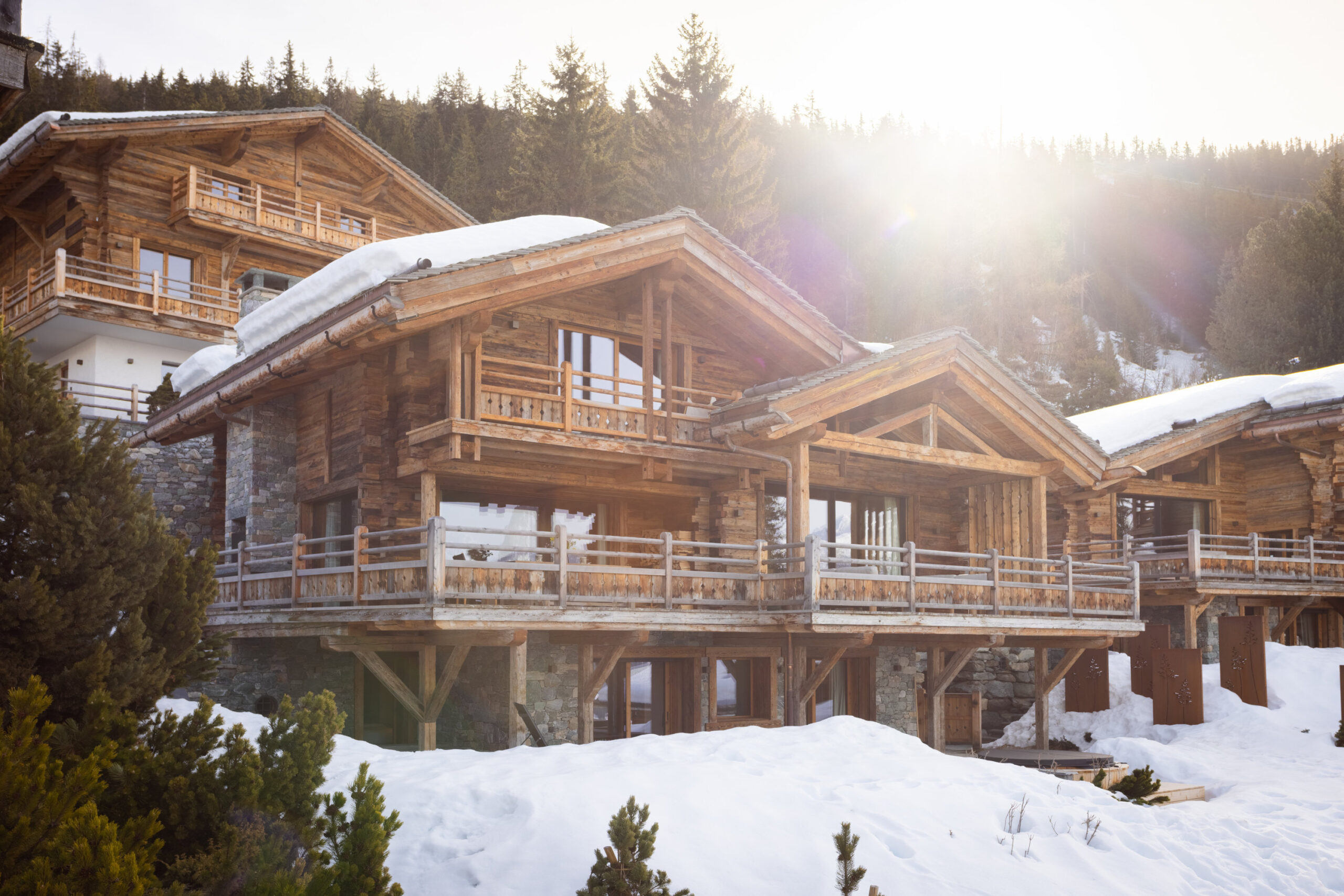 Exterior view of Chalet Pierrier in Verbier in low winter sunlight