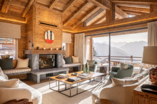 Lounge area in the daytime with views of the mountains at Chalet Pierrier in Verbier