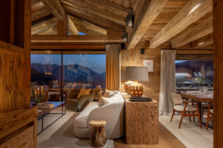 Lounge and dining area at dusk at Chalet Pierrier in Verbier