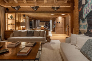 Lounge and dining area at night at Chalet Pierrier in Verbier