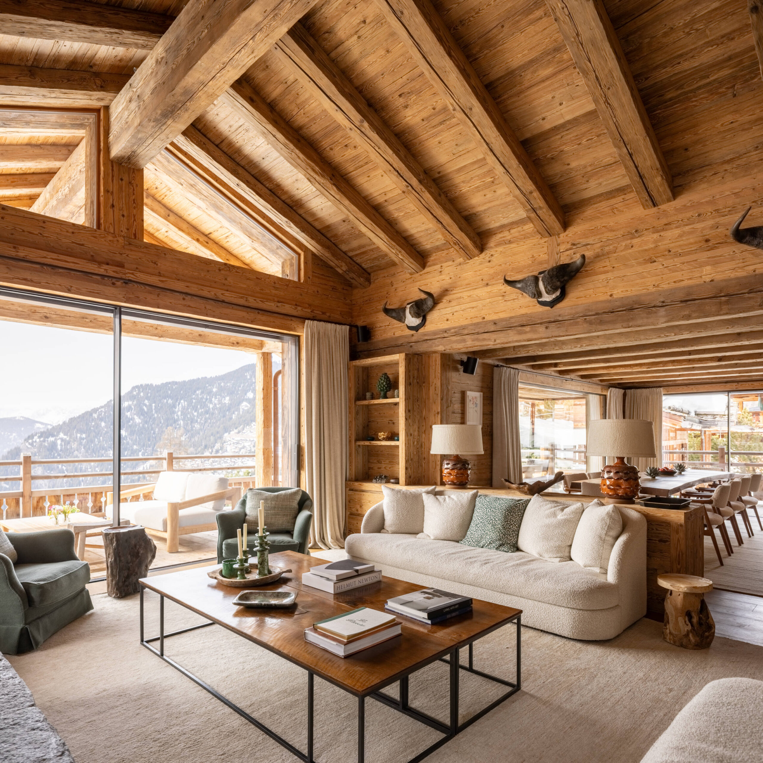 Lounge area with vaulted ceilings and double height windows at Chalet Pierrier in Verbier