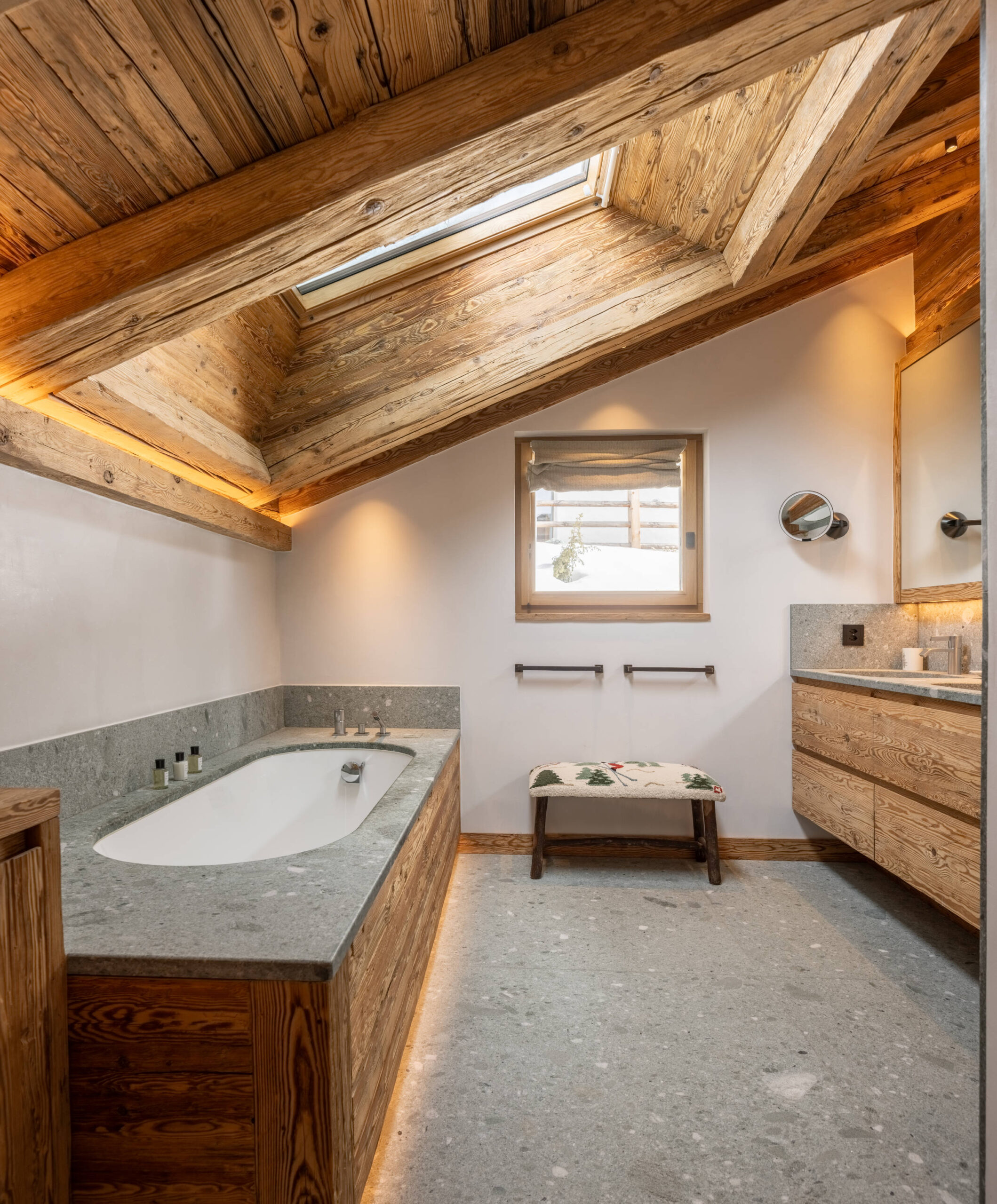 MAster bathroom with oval bathtub and twin sinks at Chalet Pierrier in Verbier