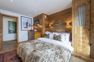 Bedroom two with open doorway at Apartment Silver in Verbier
