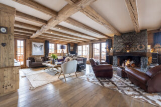 Fireplace and lounge seating areas in the living spave at Apartment Silver in Verbier