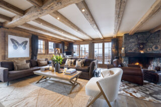 Lounge seating area with French doors to balcony at Apartment Silver in Verbier