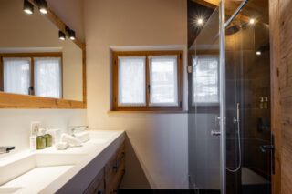 Bedroom four en suite shower room with twin sinks at Chalet Sirocco in Verbier