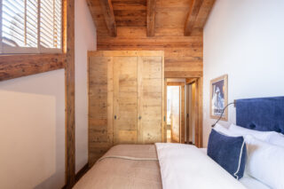 Bedroom four high ceilings and connecting door to bedroom three at Chalet Sirocco in Verbier