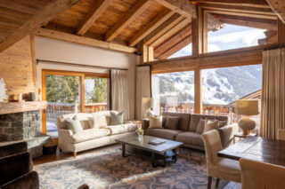 Lounge area with corner sofas and view of the pistes